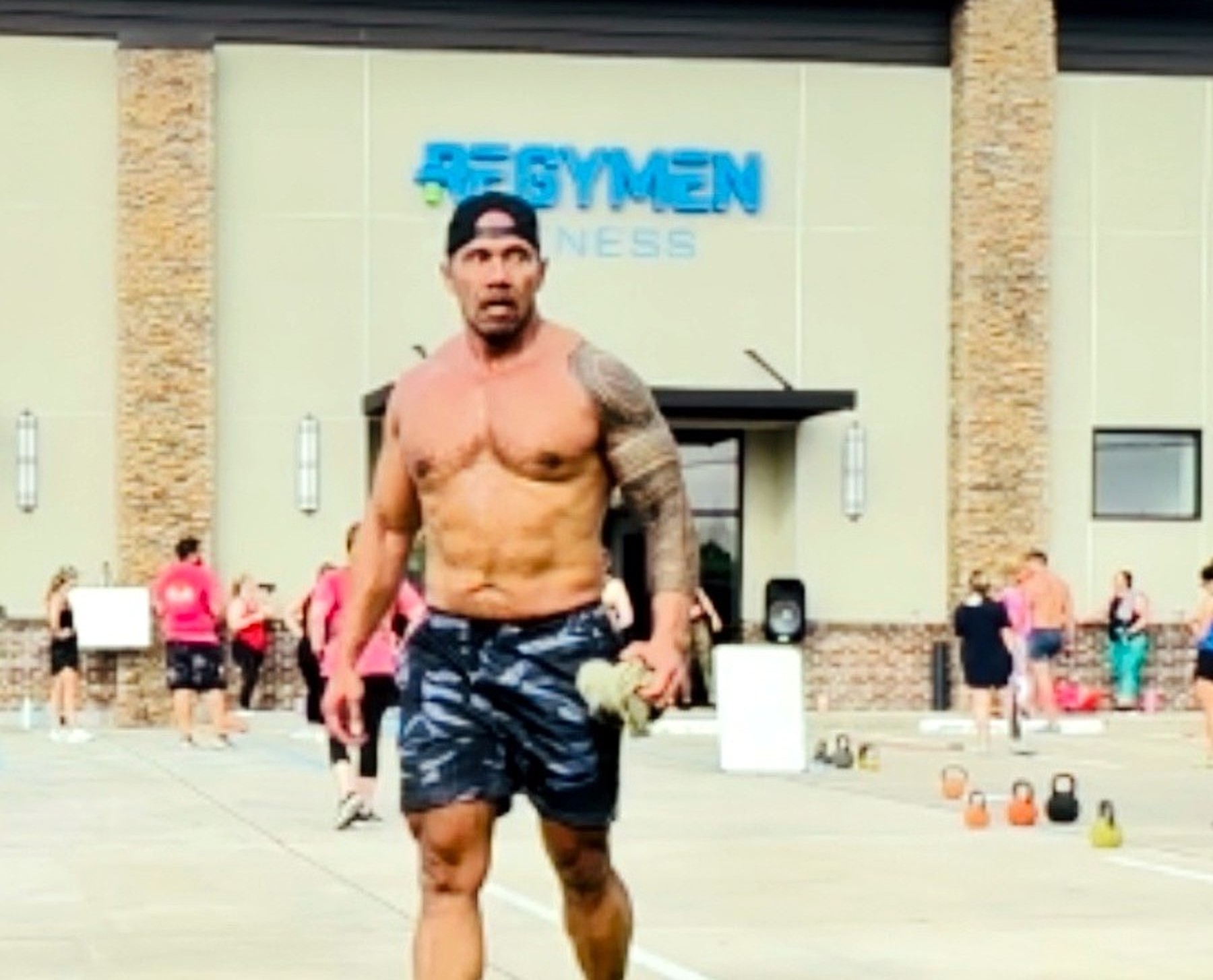 Coach Laie leading the quarterly outdoor workout at Regymen Fitness Ascension, the crew training behind him